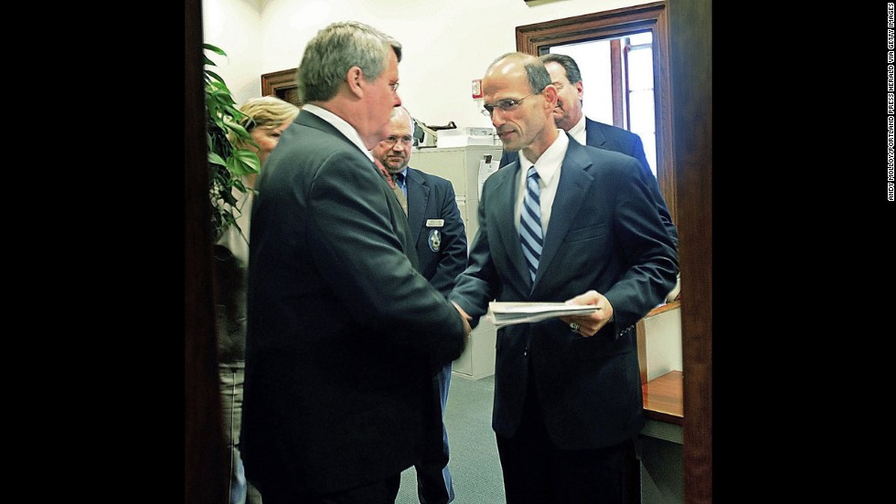 Maine state Sen. Dennis Damon, left, hands Gov. John Baldacci the bill that the state Senate passed in May 2009 to affirm the right of same-sex couples to marry.