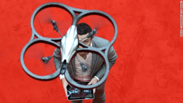 NUREMBERG, GERMANY - FEBRUARY 02:  A  man controls an AR. Drone made by parrot with an Ipad during the press preview day of the International Toy Fair Nuernberg on February 2, 2011 in Nuremberg, Germany.   2,683 exhibitors will present their new toy products until February 8, 2011.  (Photo by Miguel Villagran/Getty Images)