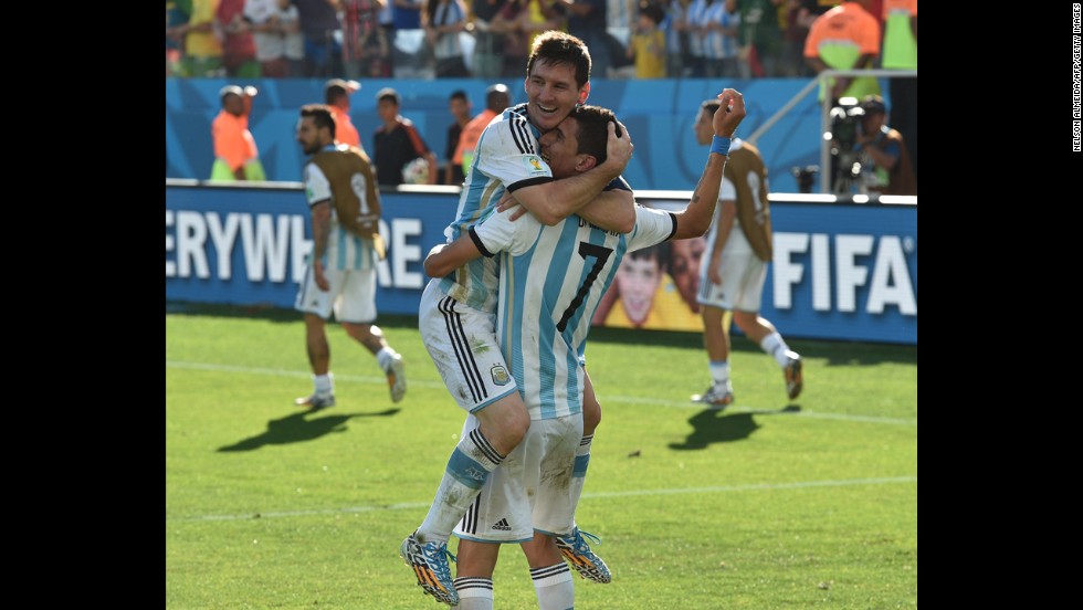 Argentina players Lionel Messi, left, and Angel Di Maria celebrate after Di Maria scored the winning goal in extra time to beat Switzerland 1-0 and advance to the World Cup quarterfinals.