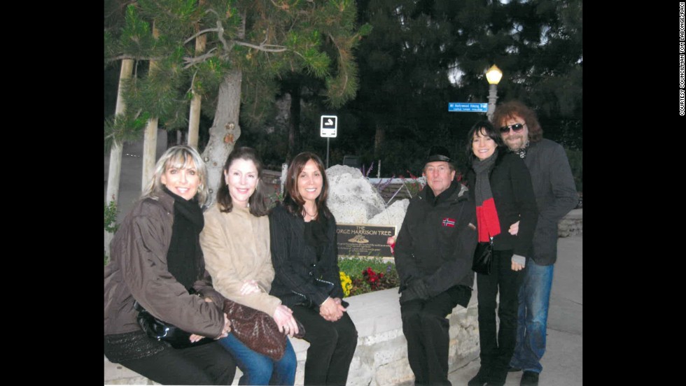 The George Harrison tree in LA&#39;s Griffith Park is behind family and friends including Harrison&#39;s widow, Olivia (center, in black), Eric Idle of Monty Python fame near her, and Jeff Lynne (far right) of ELO and Harrison&#39;s band The Travelling Wilburys. The tree was killed by an infestation of beetles.