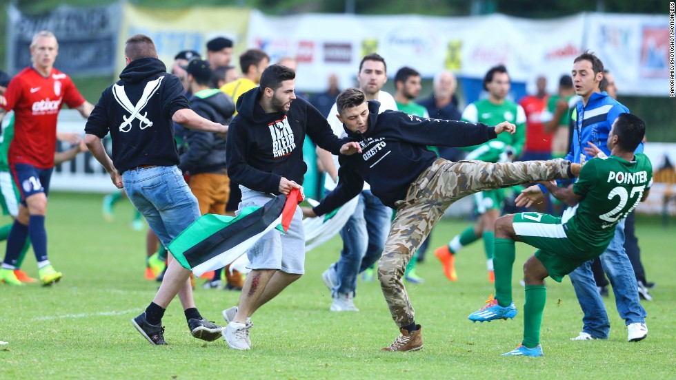 A Palestinian supporter kicks a member of the Israeli soccer team Maccabi Haifa on Wednesday, July 23, after protesters snuck onto the field during a preseason match against French club Lille OSC in Bischofshofen, Austria.