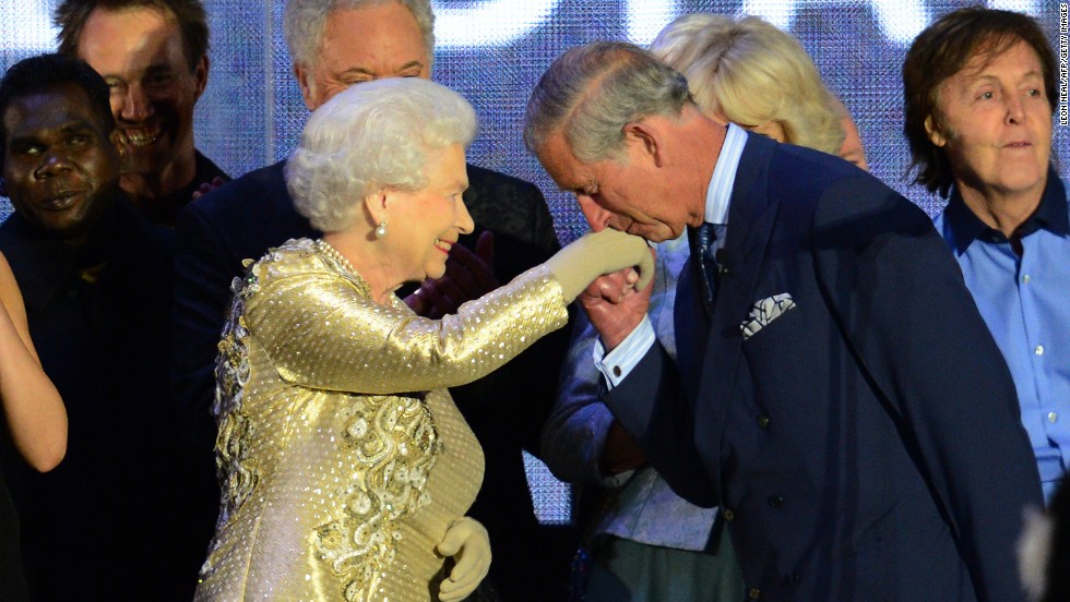 Prince Charles kisses his mother's hand on stage as singer Paul McCartney, far right, looks on at the Diamond Jubilee concert held June 4, 2012, at Buckingham Palace. The Diamond Jubilee celebrations marked Elizabeth's 60th anniversary as Queen.