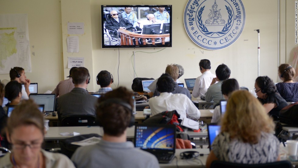 Cambodian and international journalists watch a live video feed showing the verdicts in the trial of former Khmer Rouge leader "Brother Number Two," Nuon Chea, and former Khmer Rouge head of state Khieu Samphan, August 7, 2014.