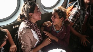 Aziza Hamad, 14, talks to her mother minutes after being rescued from Mount Sinjar in Iraq on August 14, 2014. A year after she and other Yazidi Iraqis were saved from the murderous advance of ISIS, CNN&#39;s Ivan Watson tracked Aziza down.