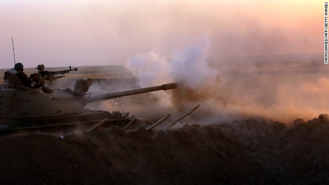 Kurdish Peshmerga fighters fire at ISIS in Khazair, Iraq, on Thursday, August 14.