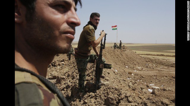 Kurdish Peshmerga forces stand guard at their position in the Omar Khaled village west of Mosul on Sunday, August 24.