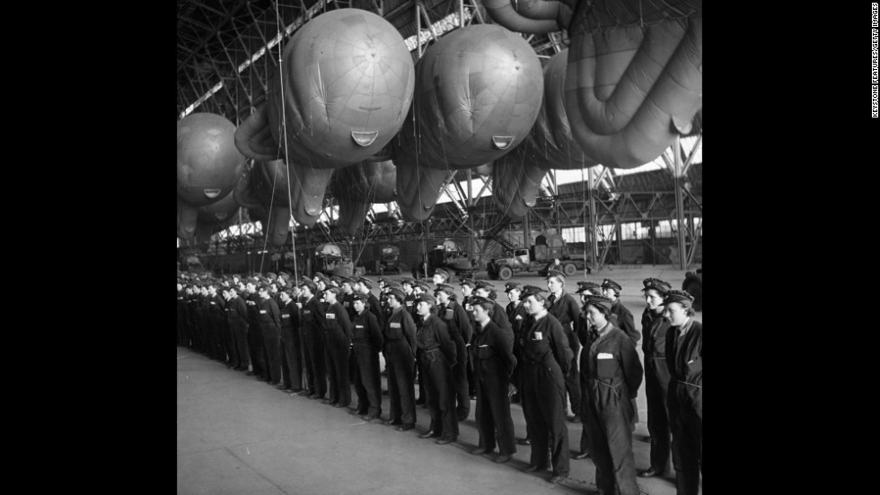 Balloon operators from Britain&#39;s Women&#39;s Auxiliary Air Force, or WAAF, report for inspection in a hangar used to store balloons, at a facility in the UK. During World War II, women played a significant role in the war effort. They took jobs in &quot;defense plants and volunteered for war-related organizations, in addition to managing their households,&quot; according to the World War II museum in New Orleans.