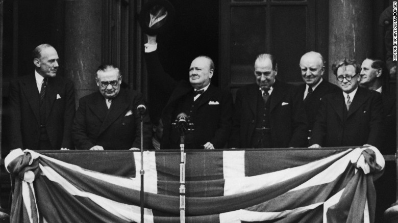 British Prime Minister Winston Churchill addresses the celebrating crowds from the balcony of the Ministry of Health in Whitehall, London, on V-E Day, May 8, 1945. The war in Europe was officially over.