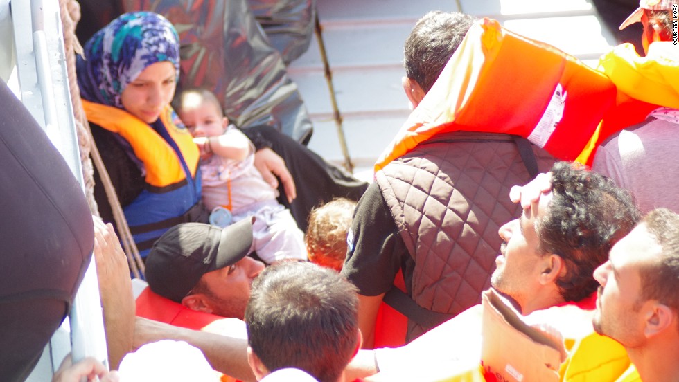 Refugees receive help from rescue boat &quot;Phoenix.&quot;