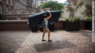 Emma Sulkowicz of Columbia University carries a mattress in protest of the university&#39;s lack of action after she reported being raped.