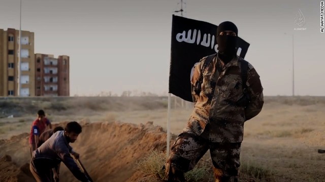 An ISIS fighter, who speaks perfect English with a North American accent, is shown orchestrating the mass execution of a group of men in an ISIS recruitment video called &quot;Flames of War&quot;.