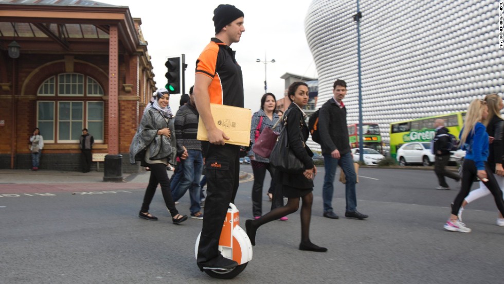 A &quot;postie&quot; trials the Airwheel unicycle in Birmingham. The company says the devices are now becoming popular with urban commuters.