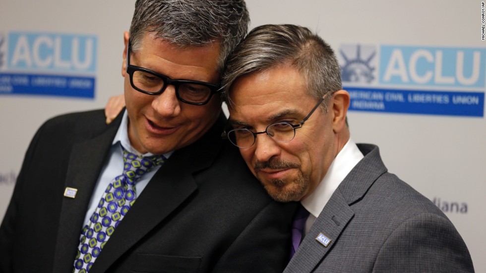 Rob MacPherson, right, and his husband, Steven Stolen, hug during a news conference at the American Civil Liberties Union in Indianapolis on October 6.