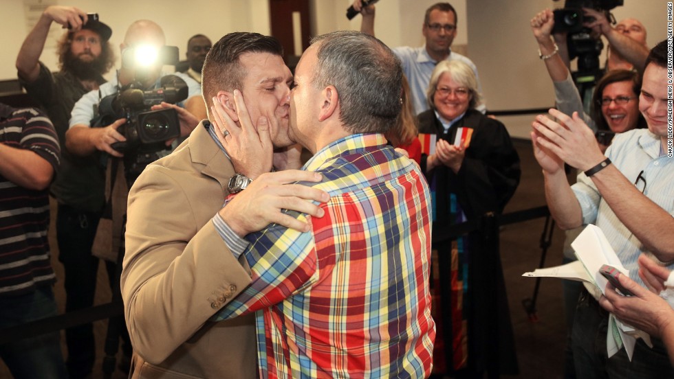 Chad Biggs, left, and his fiance, Chris Creech, say their wedding vows at the Wake County Courthouse in Raleigh, North Carolina, on Friday, October 10, after a federal judge ruled that same-sex marriage can begin there.