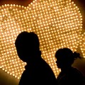 NANJING, CHINA - FEBRUARY 14: (CHINA OUT) A couple walk past hearts formed by 999 electric bulbs which were signed with people's autographs on Valentine's Day February 14, 2009 in Nanjing of Jiangsu Province, China. Valentine's Day has become one of the most popular Western festivals celebrated in China.  