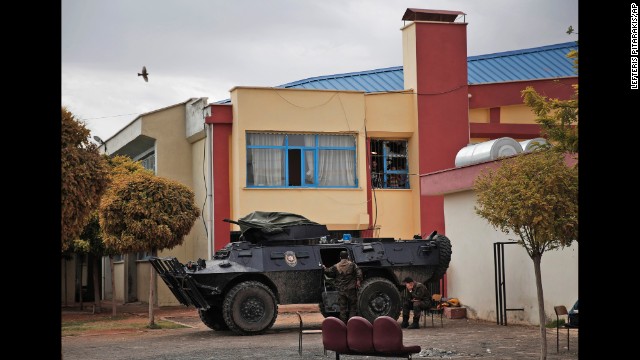 Turkish police officers secure a basketball stadium in Suruc on October 14. Some Syrian Kurds were held there after crossing from Syria into Turkey. Tens of thousands of people fled Kobani to escape ISIS.