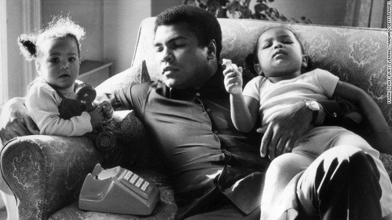 Ali sits with his daughters Laila and Hanna at the Grosvenor House in London on December 19, 1978. He briefly retired from professional boxing the following year.