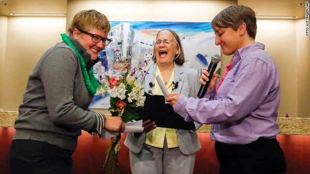 Rachael Beierle, left, and Boise City Council President Maryanne Jordan, center, laugh at a joke in Amber Beierle&#39;s wedding vows at City Hall in Boise, Idaho, on Wednesday, October 15. With Mayor Dave Bieter out of town, Jordan officiated the wedding as acting mayor. Ada County clerks began issuing marriage licenses to same-sex couples Wednesday morning.