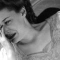 circa 1955: A woman crying as she looks at her bedside clock. (Photo by Three Lions/Getty Images