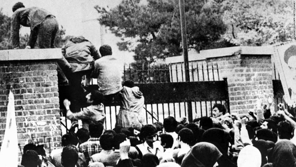 Iranian students climb over the wall of the U.S. embassy in Tehran on November 4, 1979. 