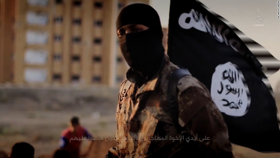 http://i2.cdn.turner.com/cnnnext/dam/assets/141117103601-isis-masked-militant-flag-horizontal-large-gallery.jpg