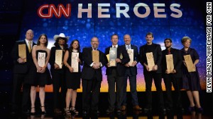 The top 10 CNN Heroes of the year pose on stage with their awards during the annual tribute show in New York.
