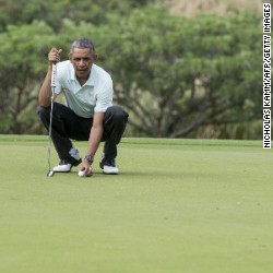 President Barack Obama prepares to putt as he plays golf with Malaysian Prime Minister Najib Razzak at the Marine Corps Base in Hawaii on Wednesday, December 24.