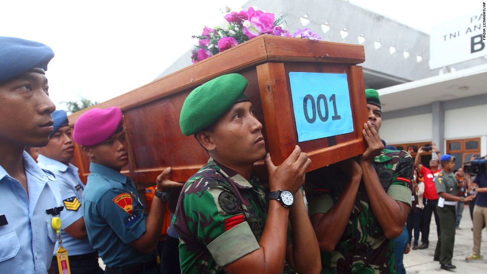 Indonesian soldiers carry a victim&#39;s coffin upon arrival at an air force base in Surabaya on Wednesday, December 31.