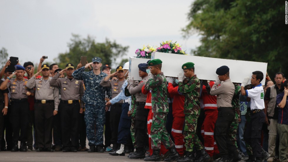 Members of the National Search and Rescue Agency and Indonesian soldiers carry coffins containing bodies of victims in Pangkalan Bun on January 2.