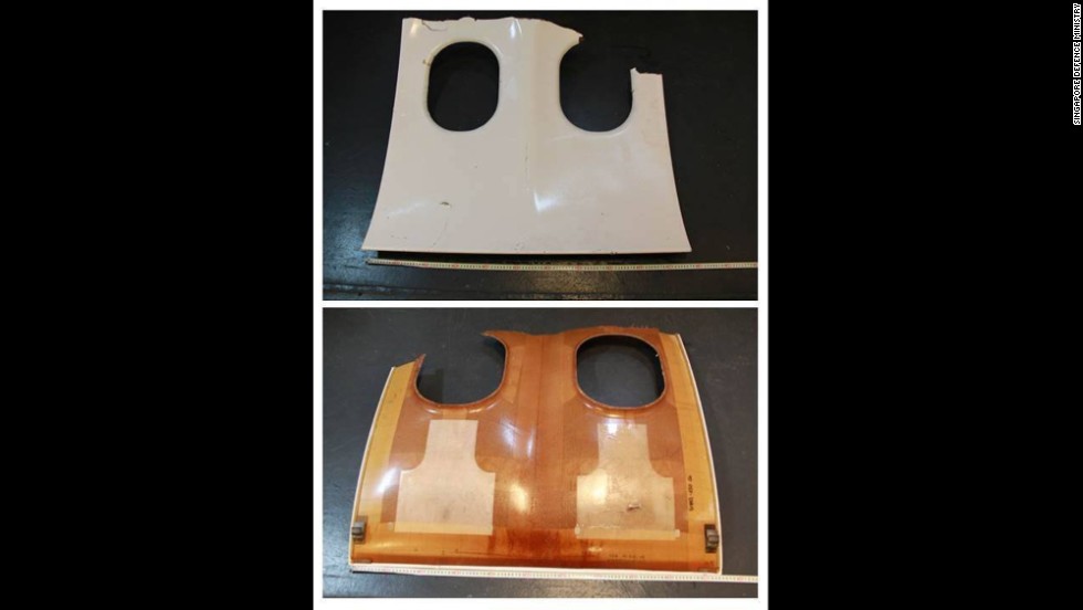 This photograph released by the Singapore Defense Ministry shows the front and back of a piece of debris that resembles an aircraft window panel.