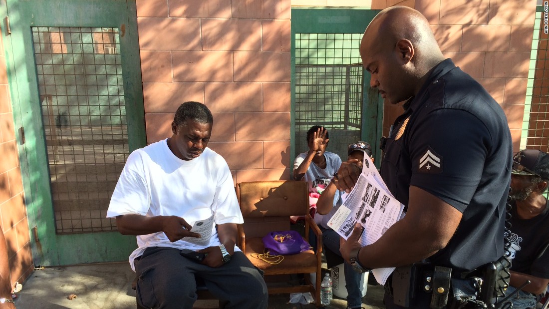 Joseph used to make more arrests: now he also hands out hygeine kits and housing information. 