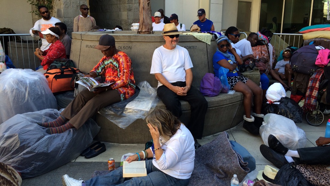 Long before the sun sets, people start lining up outside Skid Row&#39;s missions. 