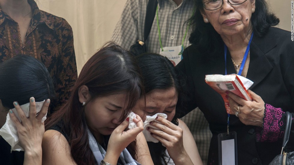 Relatives and friends grieve as they attend a ceremony January 2 in Surabaya.