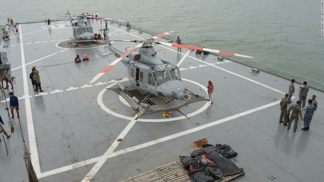 Indonesian navy officers coordinate the recovery of bodies taken to the vessel KRI Banda Aceh during recovery operations on Saturday, January 3.