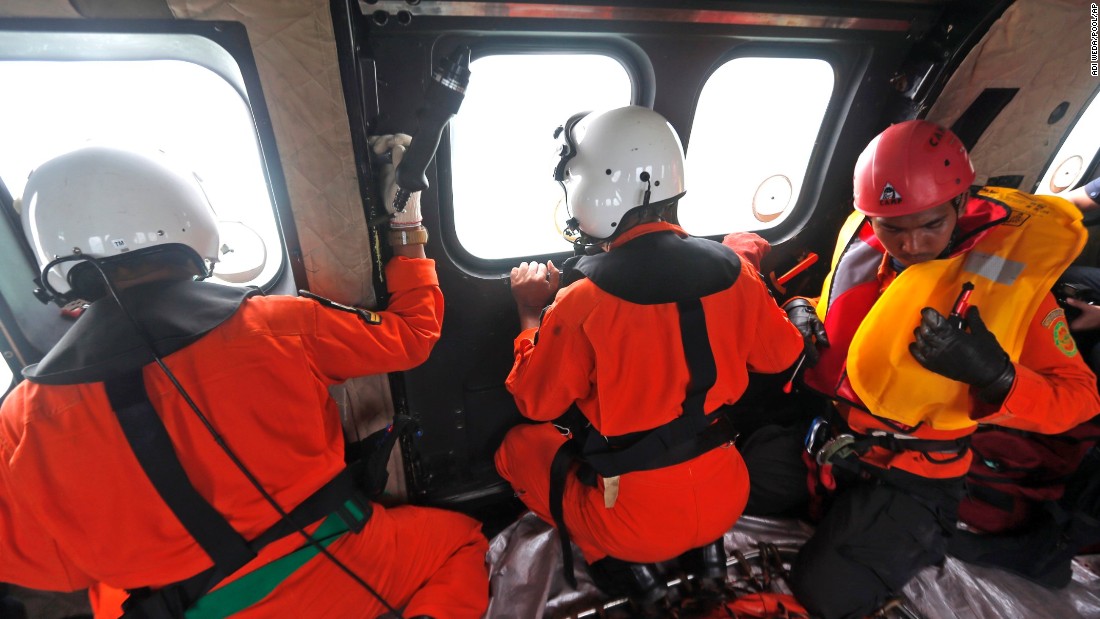 Crew members in an Indonesian air force helicopter look out of the windows over the Java Sea during a search operation on Sunday, January 4. 