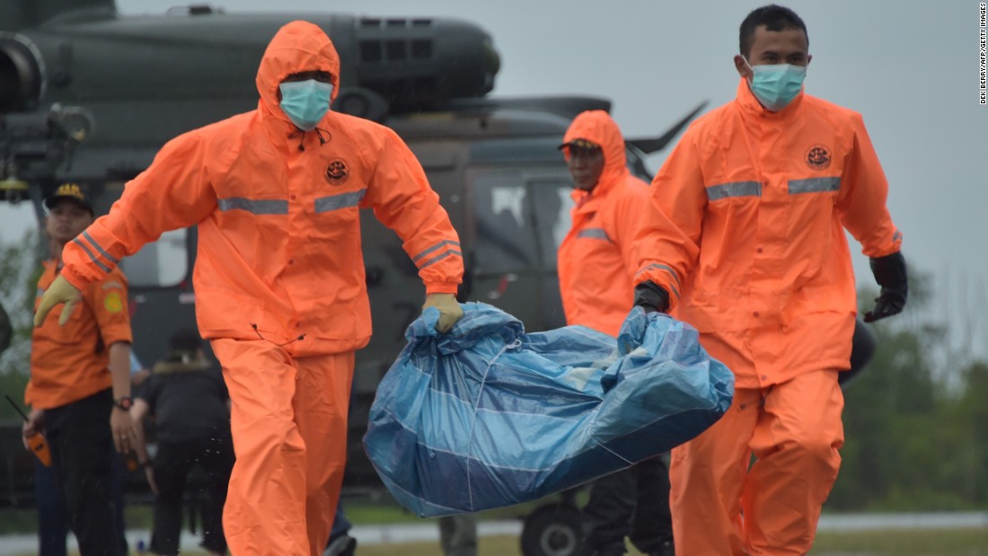 Members of an Indonesian search and rescue team carry items recovered from the search area in Pangkalan Bun on January 4.