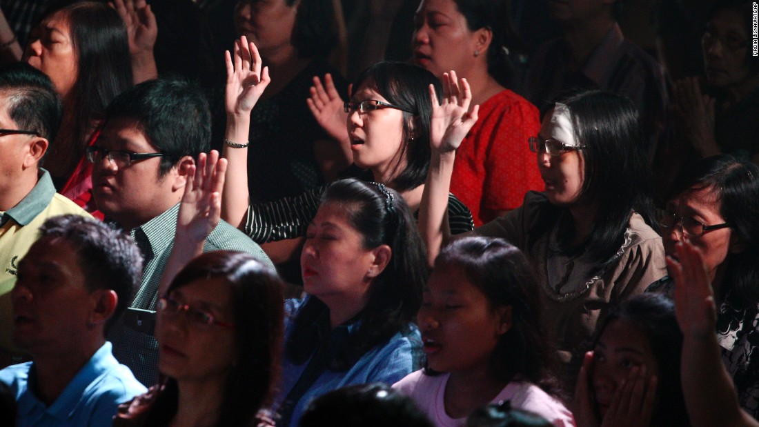 Members of the Mawar Sharon Church attend a prayer service for the relatives of lost loved ones January 4 in Surabaya, Indonesia.