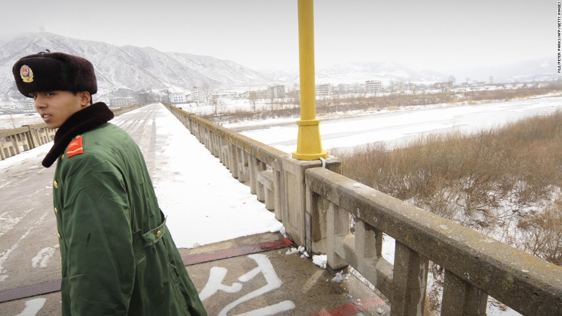 This file photo from 2009 shows a Chinese border guard patrolling on a bridge over the Tumen River that marks the border between China and North Korea.