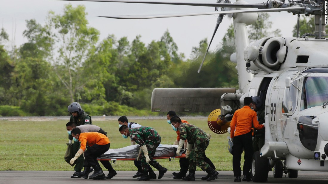 Search personnel unload the body of a victim upon arriving at the airport in Pangkalan Bun, Indonesia, on January 9.