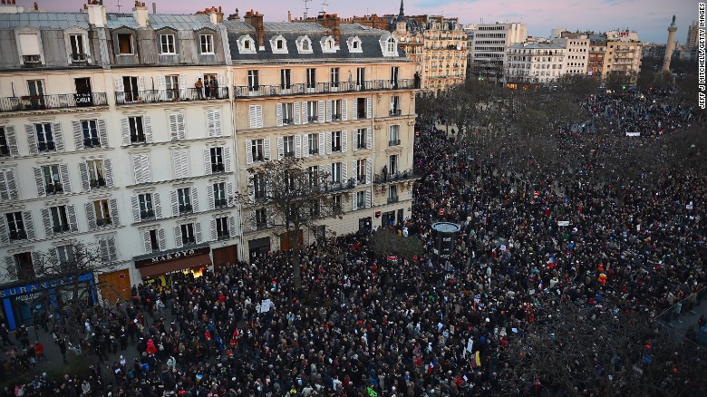 PARIS, FRANCE - JANUARY 11: Thousands of people make their way down Boulevard Voltaire, from Place de la Republique on route to Place de la Nation, during the Unity Rally following the recent terrorist attacks on January 11, 2015 in Paris, France. An estimated one million people have converged in central Paris for the Unity March joining in solidarity with the 17 victims of this weeks terrorist attacks in the country. French President Francois Hollande led the march and was joined by world leaders in a sign of unity. The terrorist atrocities started on Wednesday with the attack on the French satirical magazine Charlie Hebdo, killing 12, and ended on Friday with sieges at a printing company in Dammartin en Goele and a Kosher supermarket in Paris with four hostages and three suspects being killed. A fourth suspect, Hayat Boumeddiene, 26, escaped and is wanted in connection with the murder of a policewoman. (Photo by Jeff J Mitchell/Getty Images)