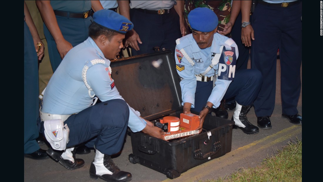 Indonesian officials remove the cockpit voice recorder from AirAsia Flight QZ8501 on Tuesday, January 13. Indonesian divers retrieved it from beneath the wreckage of the plane that crashed, with 162 people aboard, after losing contact with air traffic control on December 28. 