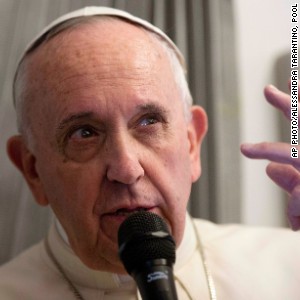 Pope Francis talks with reporters during his flight from Sri Lanka to Manila, Philippines Thursday, Jan. 15, 2015.