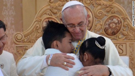 Pope Francis huging two former street children at a ceremony in Manila, Philippines, on Sunday.