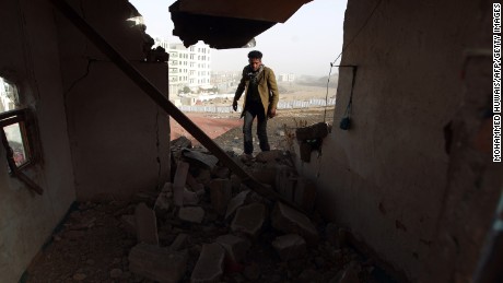 A man walks inside a heavily damaged house near the presidential palace in Sanaa, Yemen, on Tuesday, January 20. Houthi militants took control of the presidential palace, Yemen&#39;s Minister of Information Nadia Sakkaf told CNN, a day after heavy fighting ended in a ceasefire deal.