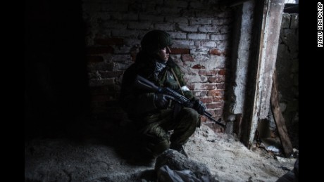 A pro-Russian rebel takes cover from shelling in the Kievsky district of Donetsk on Thursday, January 22.