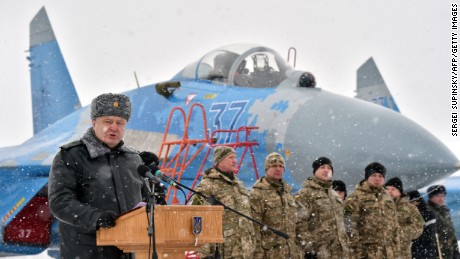 Ukrainian President Petro Poroshenko gives a speech as he hands over new military equipment to forces near the city of Ghytomyr, Ukraine, on Monday, January 5.