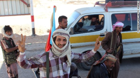 Supporters of the separatist Southern Movement flash the victory sign after they seized police security checkpoints on Saturday, January 24, in Ataq, the capital of the Shabwa province in Yemen. Policemen were told to give up their weapons and return to their bases before the militiamen raised flags of the formerly independent South Yemen at the checkpoints.
