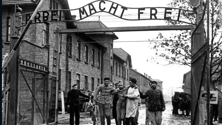 A doctor, center, with  the 322nd Rifle Division of the Red Army, walks with a group of survivors at the entrance to the newly liberated Auschwitz I concentration camp in January 1945. The Red Army liberated the camp on January 27, 1945. Above the gate is the motto &quot;Arbeit macht frei,&quot; which translates to &quot;Work sets you free.&quot; 