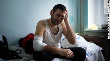 A man injured during shelling in Mariupol sits in an emergency hospital on January 26.