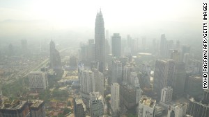 A haze has periodically wafted over Southeast Asia for 20 years. It is especially bad in the Asia-Pacific region, which has a population of over 4.2 billion and high population density. Pictured, smog hovers above the Kuala Lumpur skyline in June 2013. 